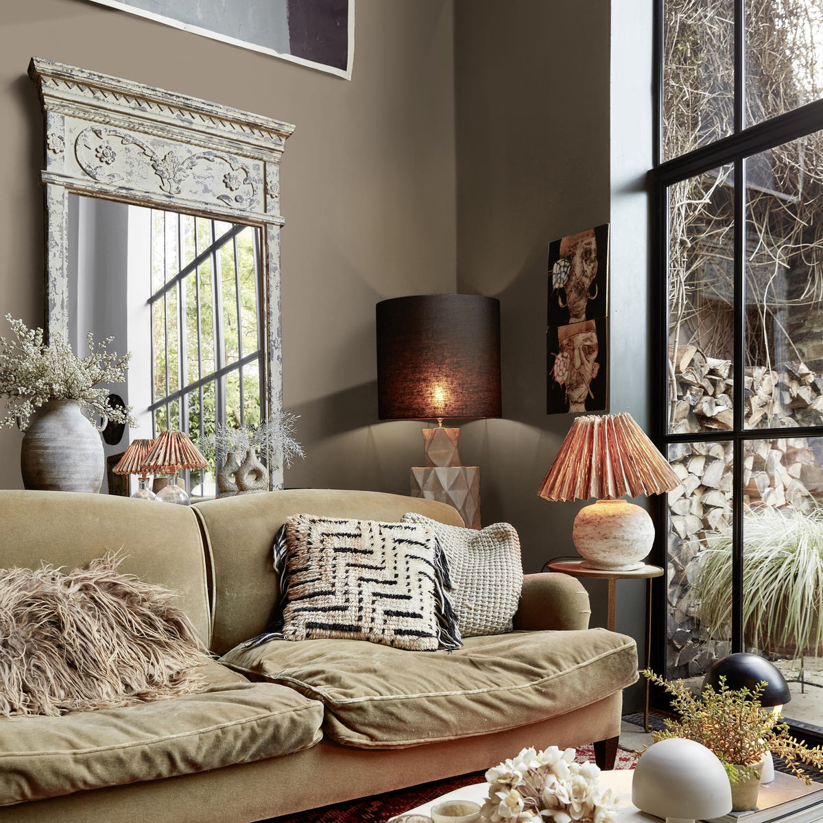 Abigail Ahern Woven Burlap paint – a sumptuous warm brown with grey undertones enveloping an eclectic, richly textural living room