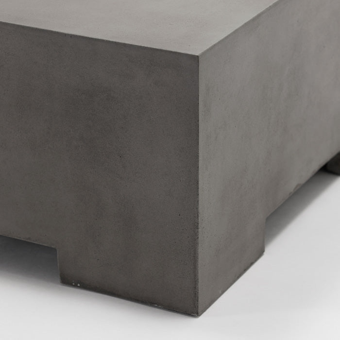 A closeup of the corner of the Beaumont Coffee Table, a grey concrete square coffee table with a cutout leg design.