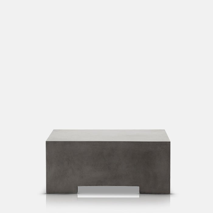 A cutout of the Beaumont Coffee Table, a grey concrete square coffee table with a cutout leg design.