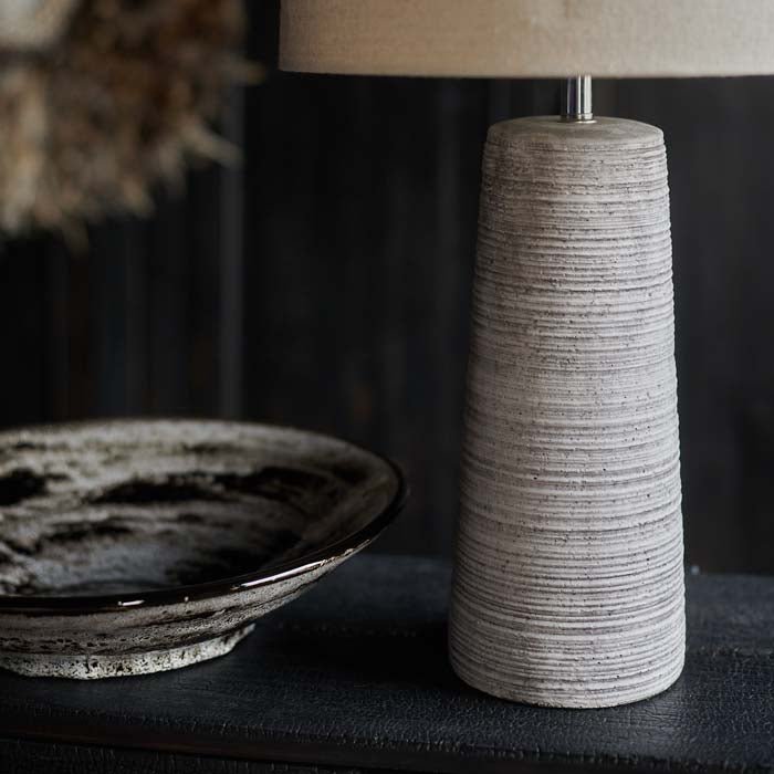 A closeup of the linear pattern on the engraved base of the Fria Table Lamp.