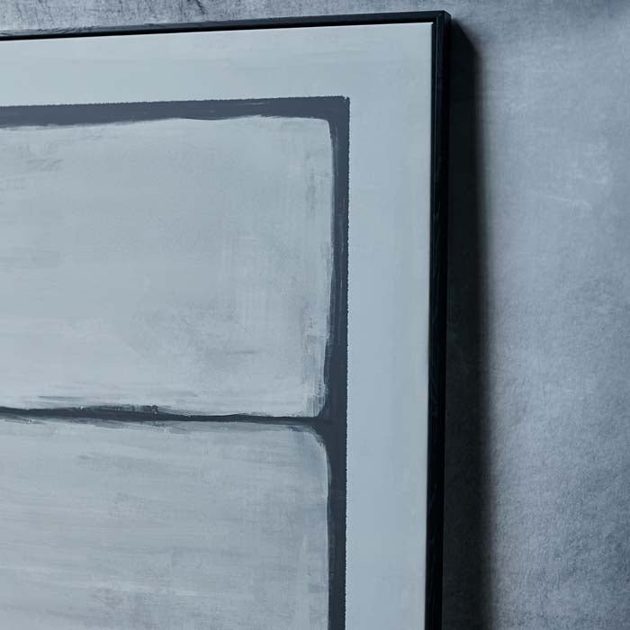 A closeup of the Saxon Abstract Print, a large abstract monochrome print in a thin black rectangular frame.