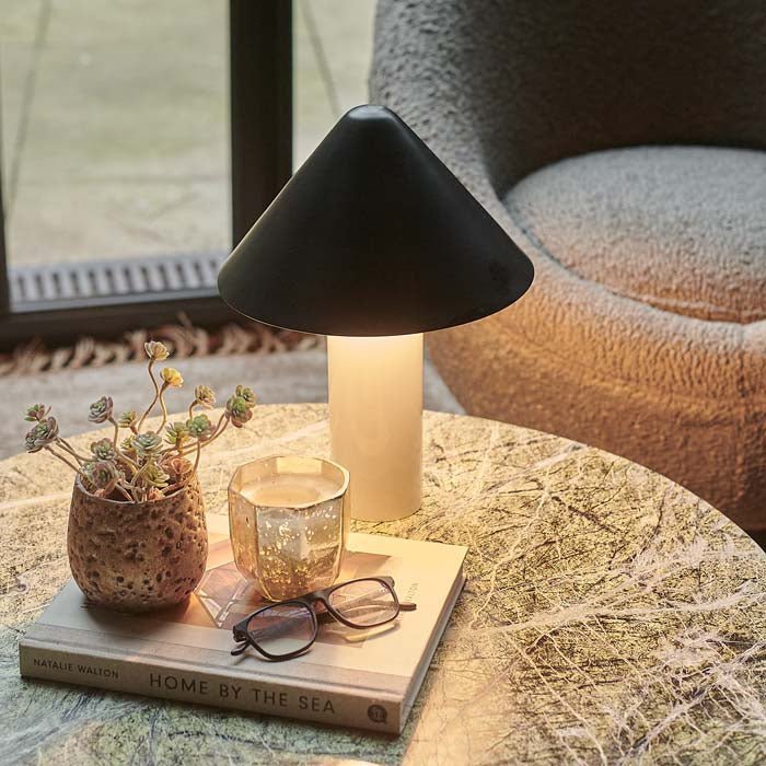 Table lamp with white base and black shade.