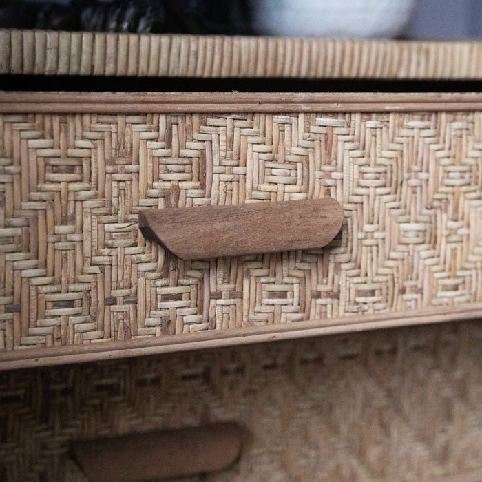 Light brown rattan drawer with long wooden handles. Woven texture adds a natural feel to your home decor.