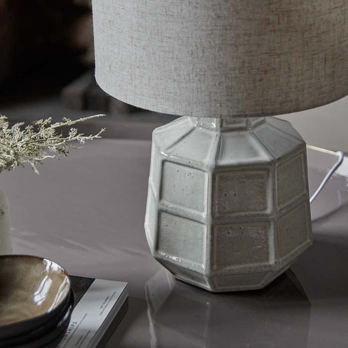 White ceramic table lamp base with grid pattern texture.