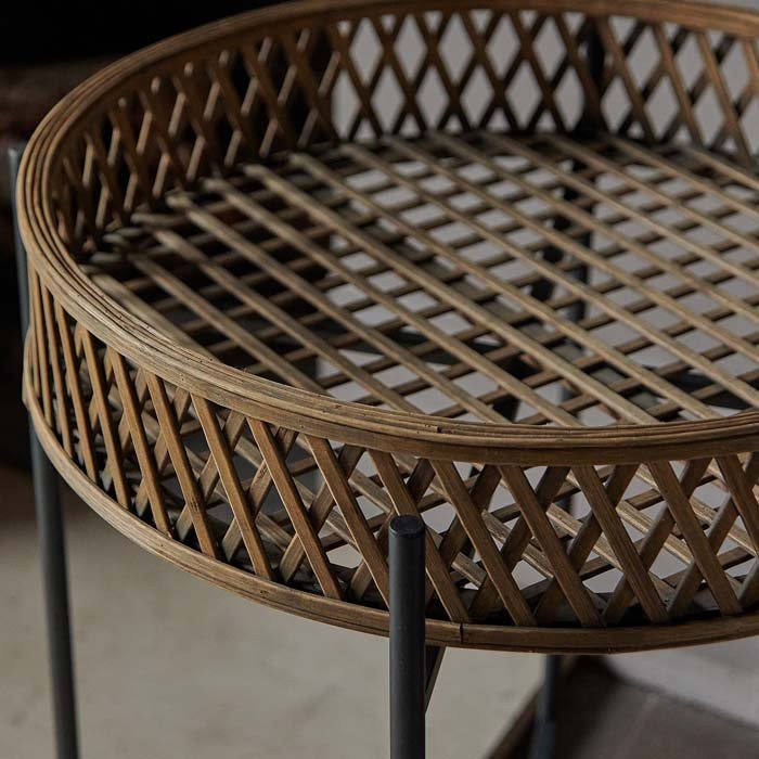 Round rattan tray table with cutouts on a black frame