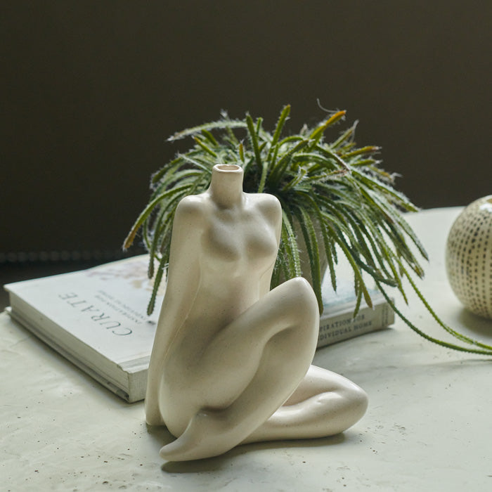 Sitting female figure vase in cream with no head 