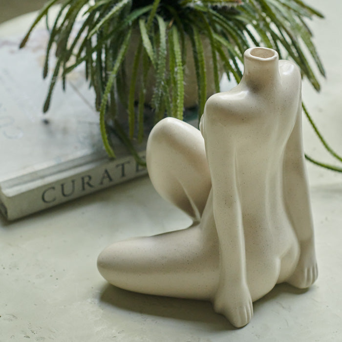Figurative female vase in cream sat facing the back