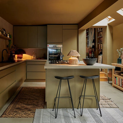 Large open plan kitchen painted in an olive green