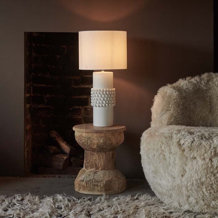Tavira Bobble Table Lamp, a smooth and bobbled white glazed ceramic table lamp styled on a spool shape wooden side table.
