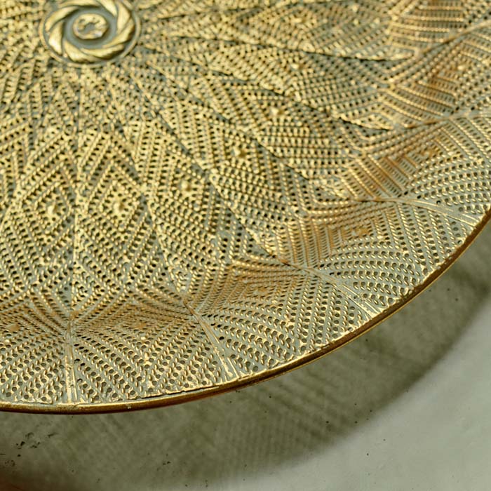 Diamond cutout details on a round golden tray\