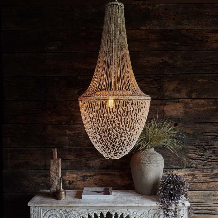 The Montauk Pendant, an artful twist on the classic shaped chandelier, made from tiny beaded shells in a delicate cream colour.