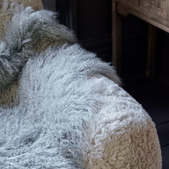 Detail of the pale grey sheepskin with a long curly haired look