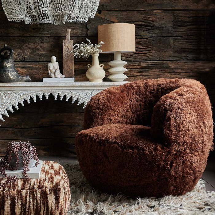 Shaggy, fur armchair in chestnut brown.