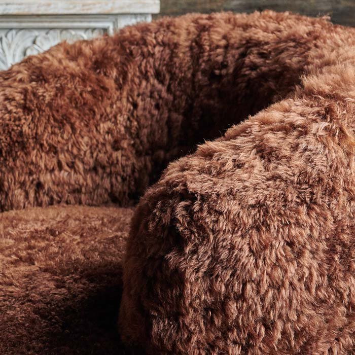 Close view of fur armchair in brown tone.