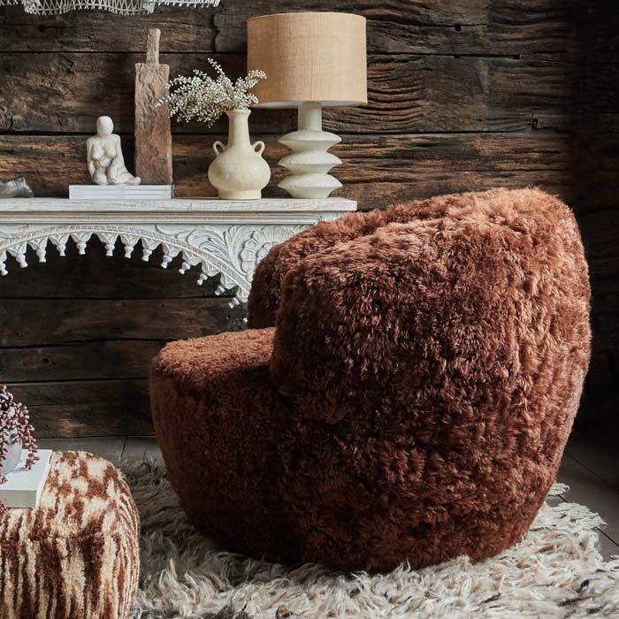 Shaggy, fur armchair in chestnut brown.