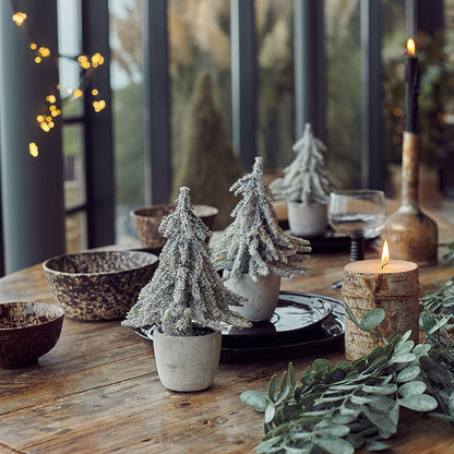 A life-like pine trees laid on a festive table spread in size medium.