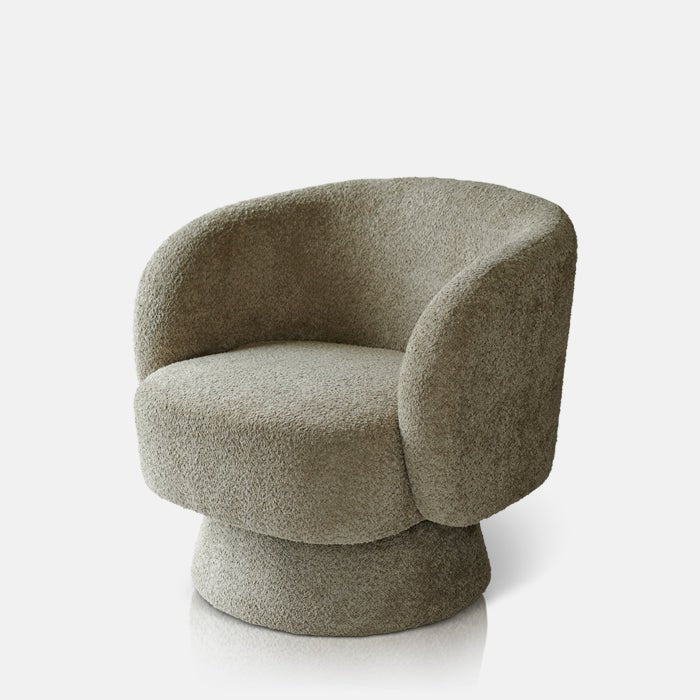 Cutout image on a white background of a modern armchair with a curved design and a beige textured fabric.