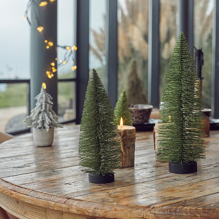 Decorations that resemble small Christmas trees displayed on a table.