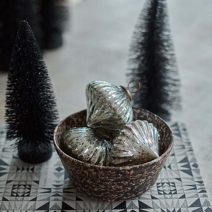 A festive decoration resembling a Christmas tree in black.