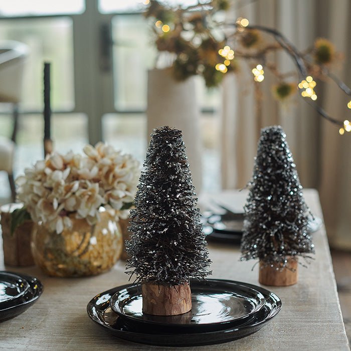 Small decorative Christmas trees covered in glitter.