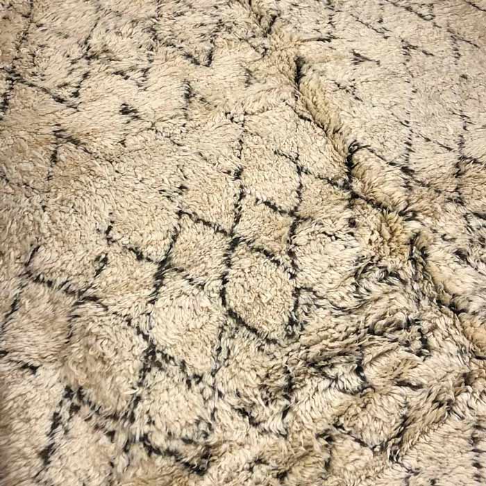 Soft, shaggy pile rug with a dark brown lozenge design