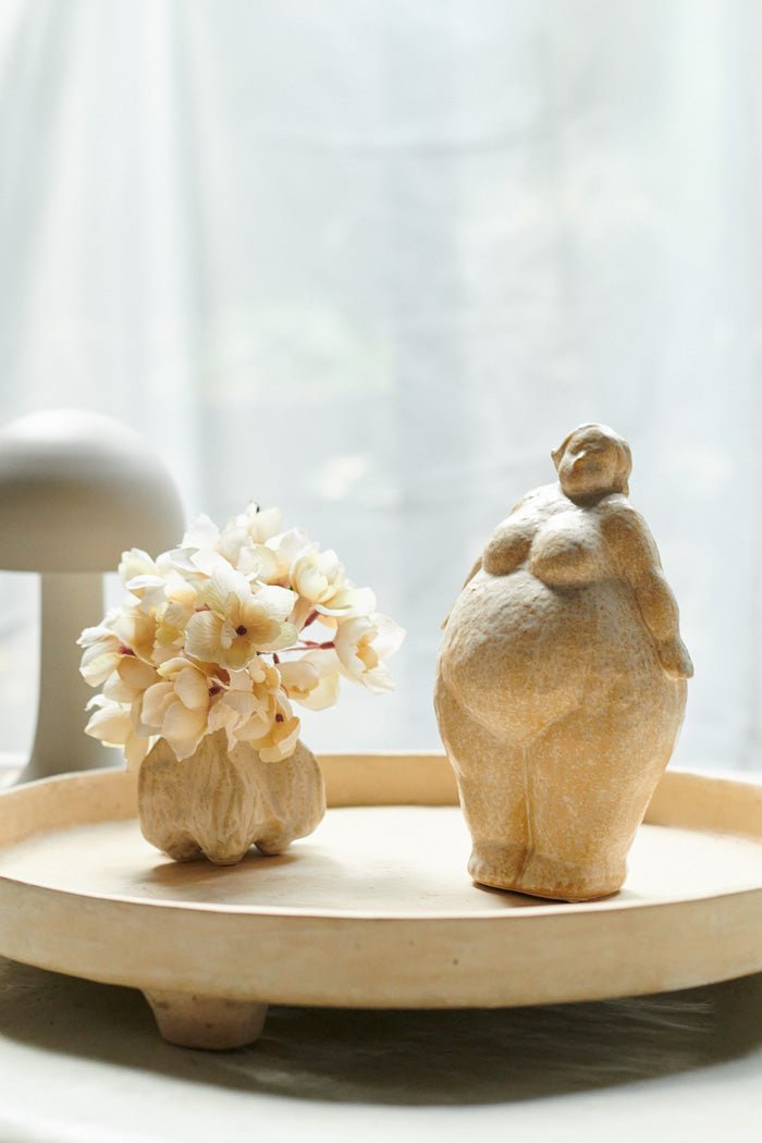 Standing curvaceous female figurine styled with other sculptures. Unique home accessories to add an arty feel.