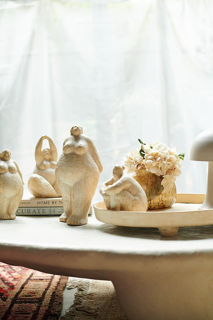 Female sculptures grouped together to make a unique statement. Curvaceous female figurines in a cream ceramic glaze to add an arty vibe.