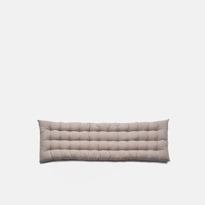 A cutout of the Enrica Headboard Cushion, a sumptuous padded rectangular headboard cushion in putty coloured cotton.