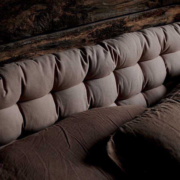  A closeup of the sumptuous padded putty coloured cotton fabric on the Enrica Headboard Cushion.