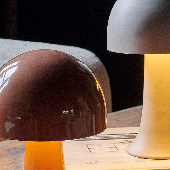 Close up image of two domed LED lamps. Both mushroom shaped lamps are lit and are emitting a soft glow.