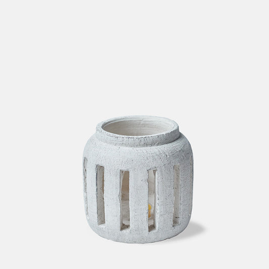 Cutout image on a white background of a rustic stoneware lantern with a cream finish.