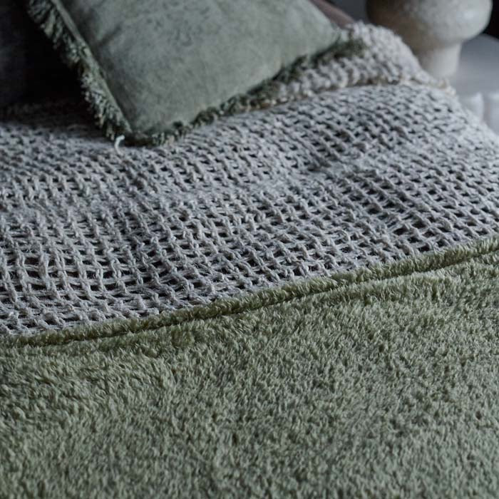 A closeup of the super-soft and snuggly sage green-hued fabric of the Winona Blanket - Sage.