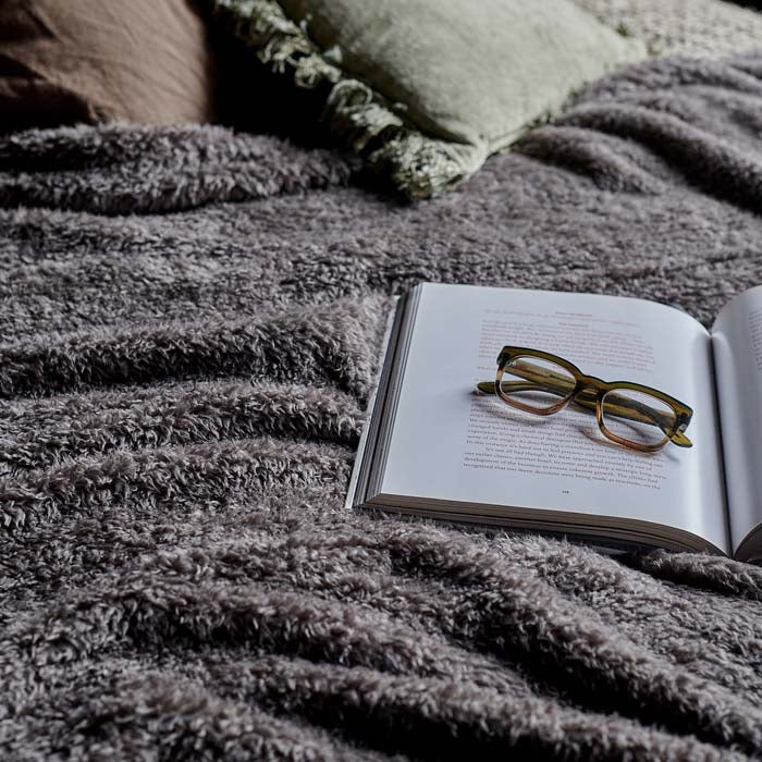 A fluffy soft blanket perfect for your bedroom or your living space. The soft stone colour contrasts well with bright colour and dark colours. 