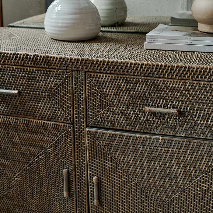 A closeup of the intricate woven rattan detailing on the front of the Merida natural Rattan Cabinet.