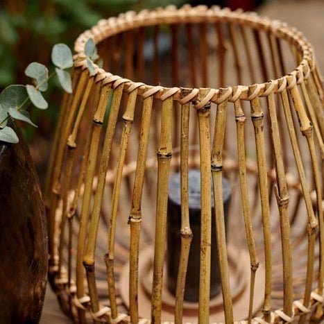A closeup of the natural hued woven bamboo on the Fabian Bamboo Candle Lantern.