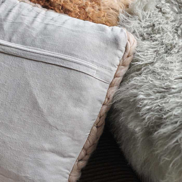 A closeup of the back part of the Rive Cushion, showing aneat folded seam for the zip.