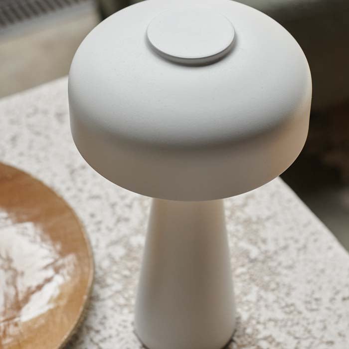 Detail image of the curved dome top of a white coloured rechargeable table lamp.