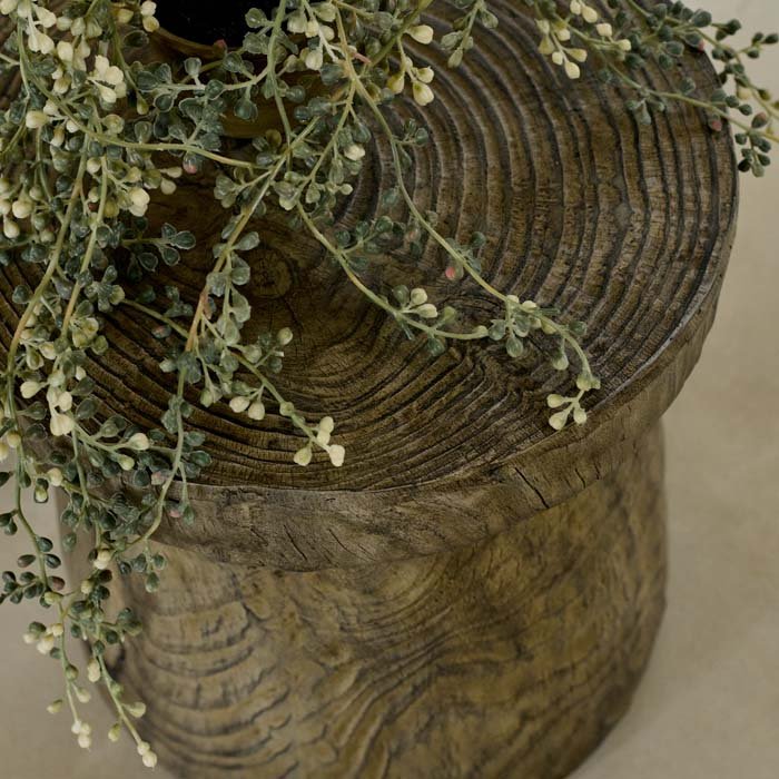A close up of the Dervio Wooden Stool. A wood-effect eco-friendly stool in a contemporary cork shape.