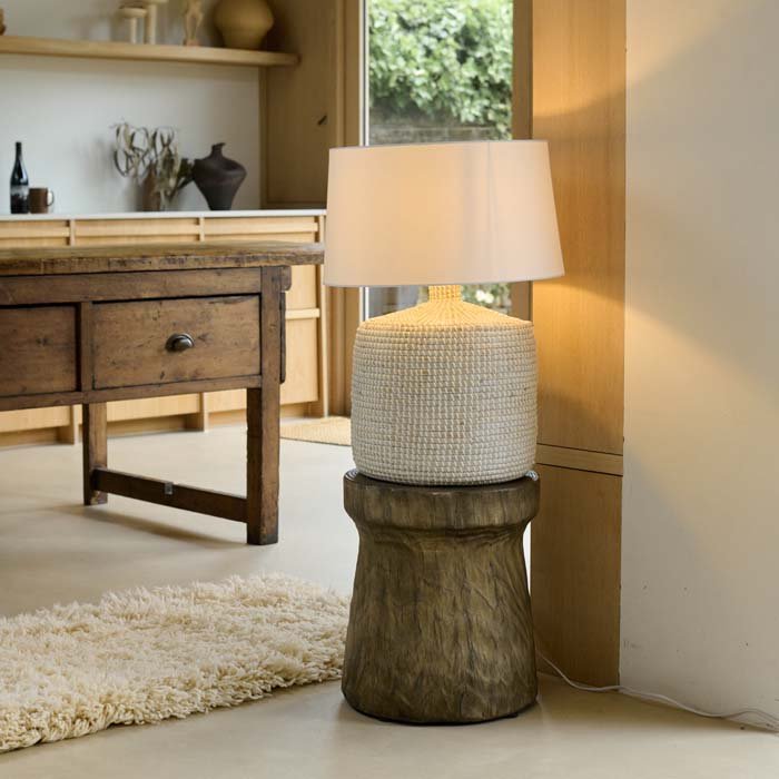 The Devoran Seagrass Lamp, a table lamp with a chunky cylindrical base made from natural seagrass and a white drum shade.