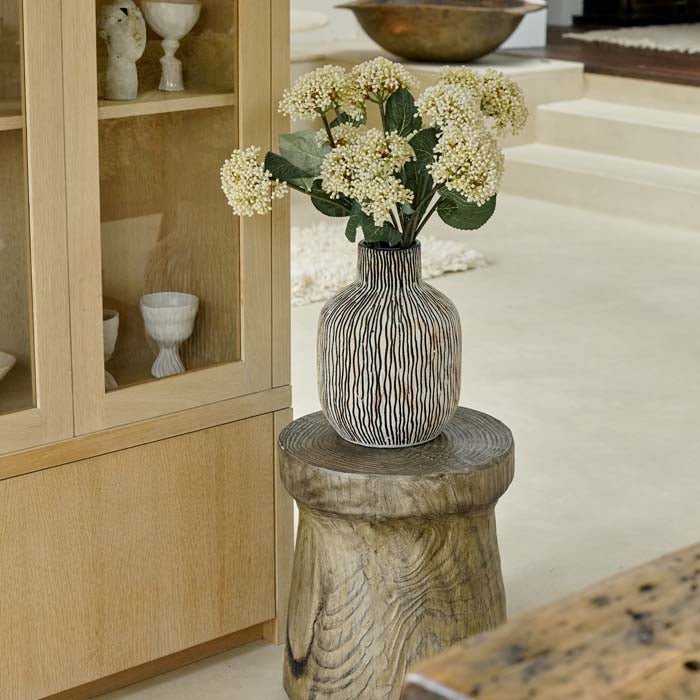 The Sahara Earthenware Vase, a large bottle shaped stone coloured vase with vertical asymmetric stripes and a rustic look.