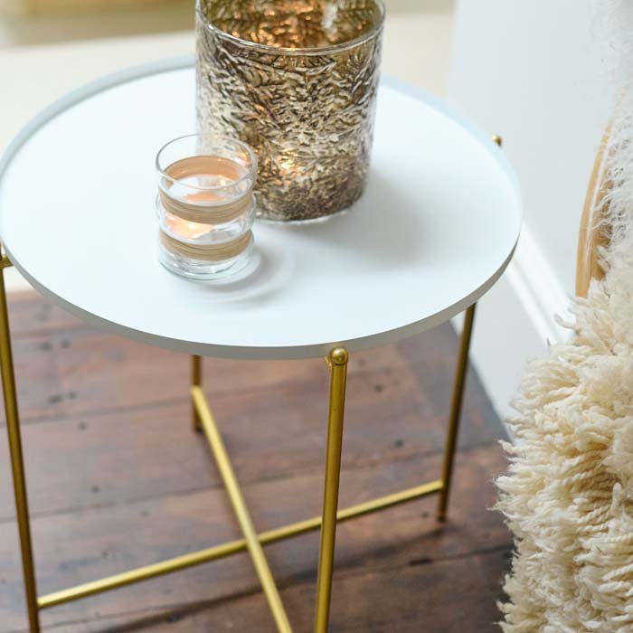 The Sandford Side Table - White, styled with a large gold coloured textured votive and a smaller clear glass one.