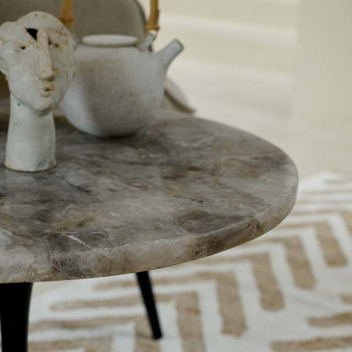 A side view of the luxe monochrome marble top of the Stamford Side Table.