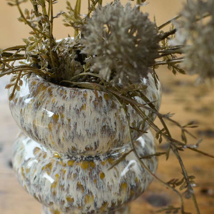 A closeup of the Tanda Stoneware Vase showing the speckled glaze in contrasting warm brown and cream tones.