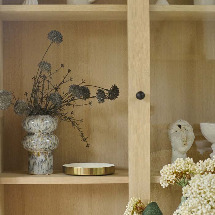 The Tanda Stoneware Vase, a a ridged cylindrical vase with a speckled glaze in contrastic warm brown and cream tones.
