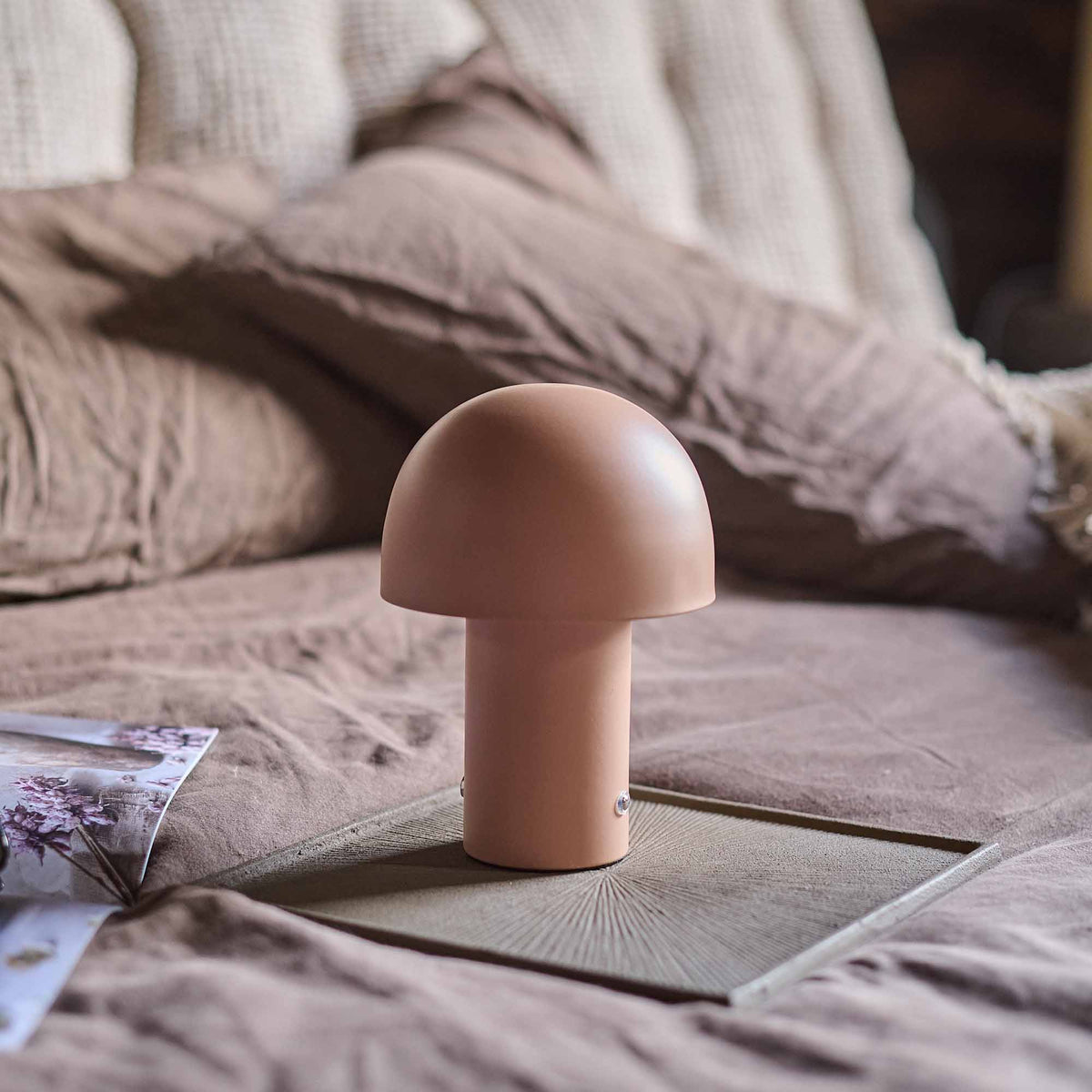 Alton Portable Table Lamp - a pink rechargeable lamp on a decorative tray.