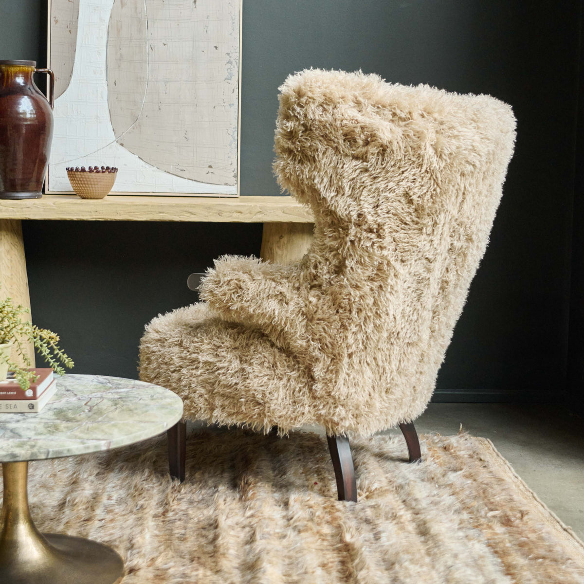 Back view Beige faux fur armchair with a soft textured finish, deep cushioned seat and timeless curved silhouette. Chalford Faux Fur Armchair by Abigail Ahern, designed for ultimate comfort and relaxed lounging while adding warmth and texture to modern interiors. A luxury accent chair perfect for living rooms, bedrooms, reading corners and cosy spaces, creating an inviting statement piece for contemporary home decor.