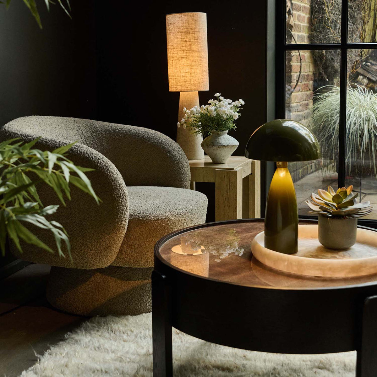 Modern living room with a textured comfortable armchair, wooden coffee table, and cool & moody interior design Taupe swivel armchair with a soft textured fabric, sculptural curved silhouette and concealed 360-degree swivel base. Harper Swivel Armchair by Abigail Ahern, designed to bring effortless comfort and flexible seating to modern living rooms, bedrooms and reading corners. A contemporary accent chair that moves with your space, adding warmth, texture and timeless style to luxury home interiors.