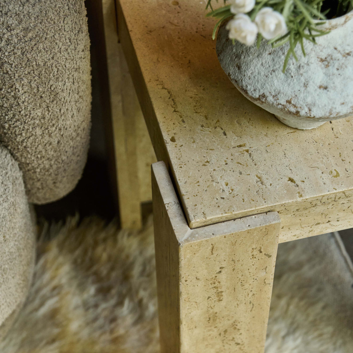 Abigail Ahern Santa Travertine Side Table with a creamy travertine stone finish, sculptural modern form and compact design for contemporary living spaces.