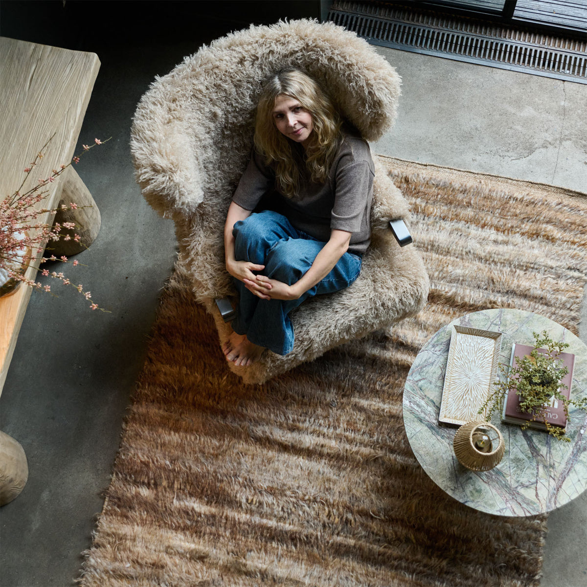 Birds eye view of a Beige faux fur armchair with a soft textured finish, deep cushioned seat and timeless curved silhouette. Chalford Faux Fur Armchair by Abigail Ahern, designed for ultimate comfort and relaxed lounging while adding warmth and texture to modern interiors. A luxury accent chair perfect for living rooms, bedrooms, reading corners and cosy spaces, creating an inviting statement piece for contemporary home decor.