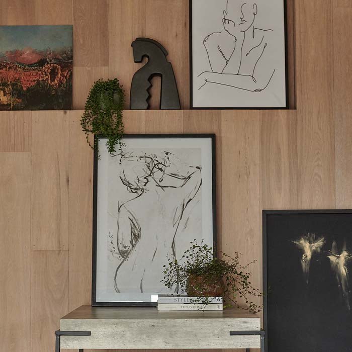 The Celia Monochrome Print, a framed female line drawing resting on a faux concrete coffee table.